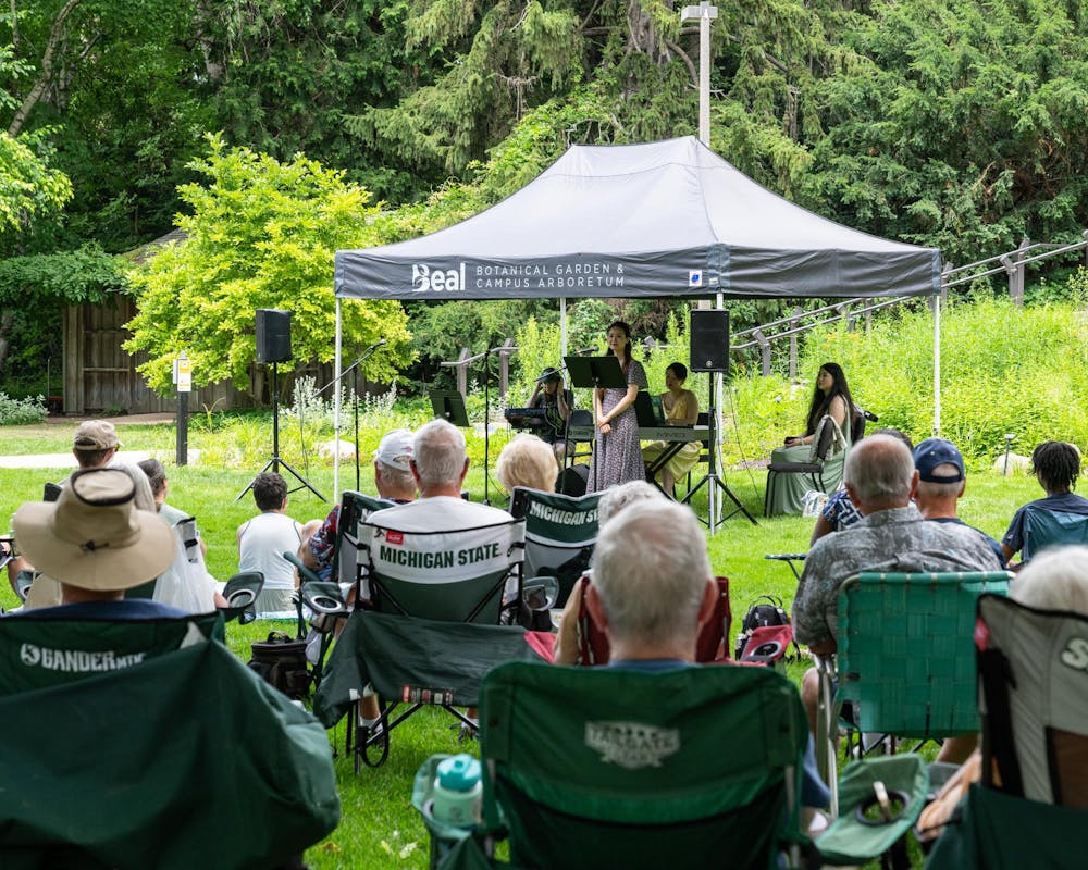 <p>The crowd listens closely as MSU Go Music Trio soprano Zimo Chen tells them about the message of their next song they will perform in East Lansing, Mich., on June 28, 2026.</p>