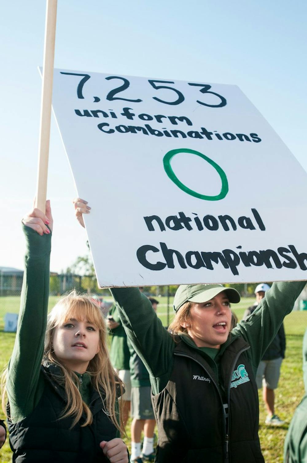 <p>Political science and prelaw sophomore Kiley Novak (left) holds up a camera as journalism sophomore Whitney Pierce displays a poster on Sept. 12, 2015, at ESPN's College Gameday at Munn field. Hundreds of students arrived early in the morning for a chance to see the live taping. Jack Stephan/ The State News</p>