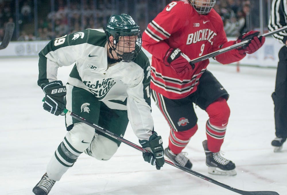 <p>Junior forward Matt DeBlouw skates down the ice past Ohio State forward Kevin Miller Jan. 24, 2015, during the game against  Ohio State at Munn Ice Arena. The Spartans defeated the Buckeyes, 2-0. Kelsey Feldpausch/The State News.</p>