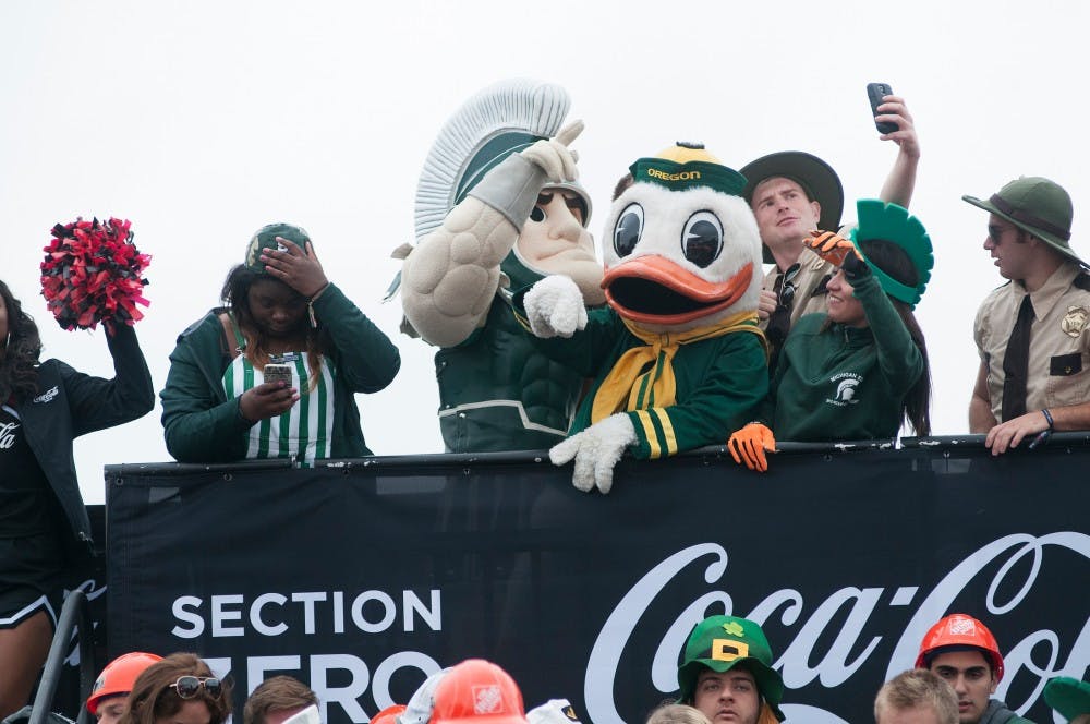 <p>Sparty and the Oregon Duck pose with fans on Sept. 12, 2015, at ESPN's College Gameday at Munn field. Hundreds of students arrived early in the morning for a chance to see the live taping. Jack Stephan/ The State News</p>