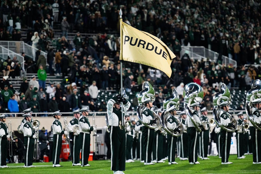 <p>A Spartan Marching Band member holds a Purdue flag at Spartan Stadium on Nov. 22, 2024.</p>