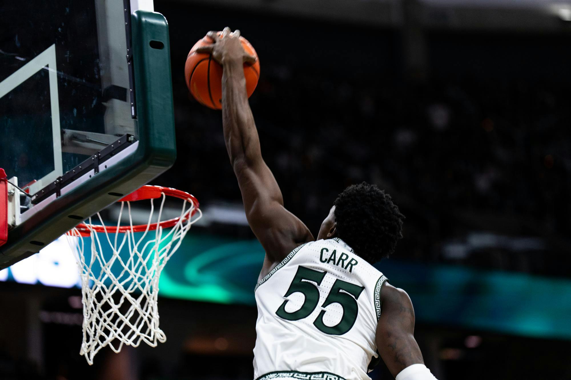 Michigan State sophomore forward Coen Carr (55) dunks the ball at the Breslin Center on March 2, 2025. The Spartans went on to clinch a 71-62 victory over the University of Wisconsin Badgers.