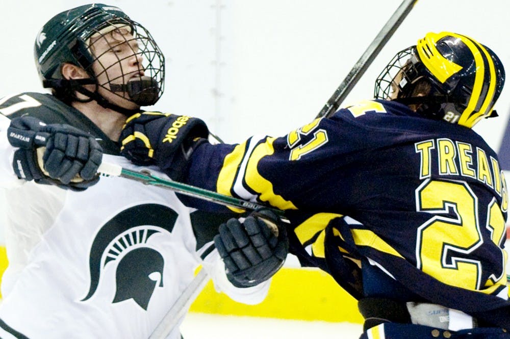 Senior defense Matt Crandell has a few words with Michigan forward A.J. Treais. The Spartans were defeated by the Wolverines 3-2 in overtime Friday night at Joe Louis Arena. Anthony Thibodeau/The State News