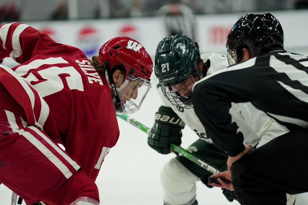 <p>Michigan State center Red Savage (21) faces off against Wisconsin center David Silye (15) at Munn Ice Arena on Nov. 17, 2023.</p>