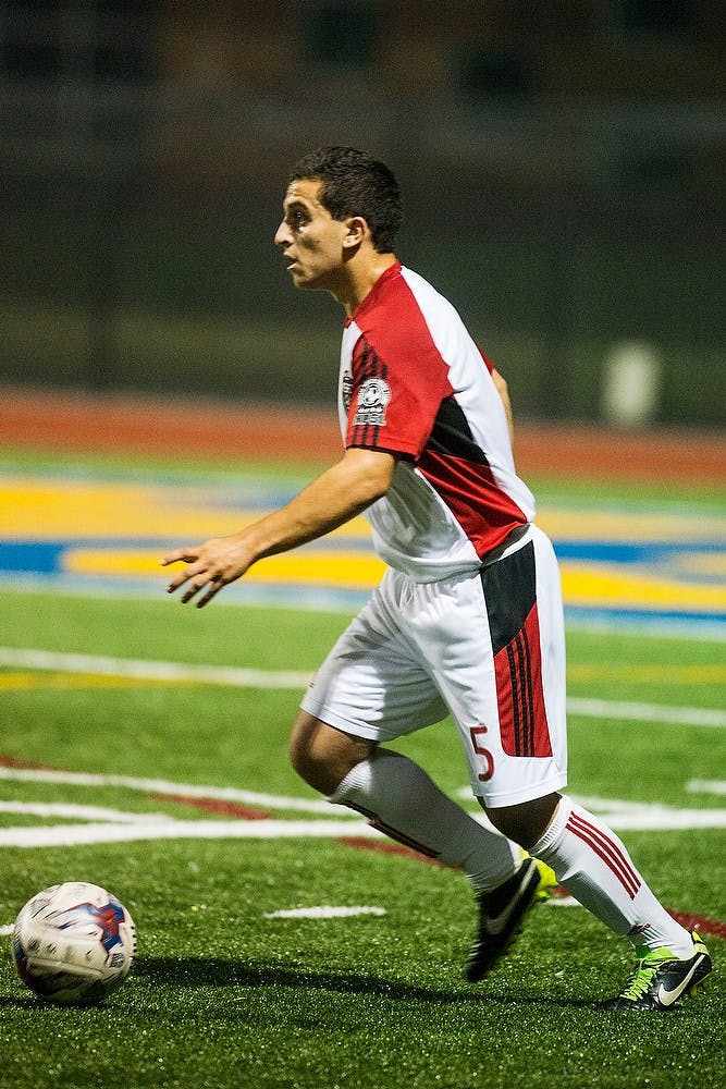 <p>Michigan Stars Football Club midfielder and alumnus Ali Cheaib looks to pass during the match against Detroit City Football Club on July 4, 2014, at Star International Academy athletic field, 6163 Fenton, in Dearborn Heights, Mich. Cheaib is one of four Spartan soccer players playing for MSFC. Danyelle Morrow/The State News</p>
