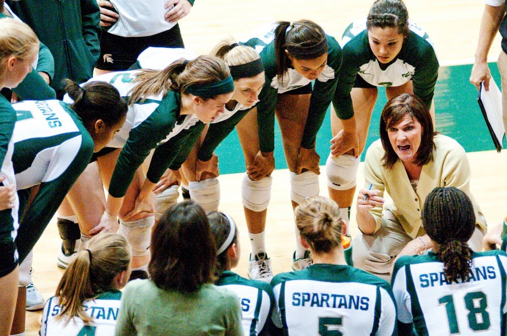 Volleyball head coach Cathy George talks with her team in the huddle during a timeout. The Spartans defeated Ball State, 3-0, on Friday night on their way to winning the Spartan Invitation this past weekend at Jenison Fieldhouse. Josh Radtke/The State News