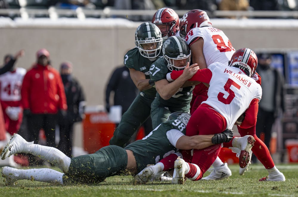 Redshirt sophomore defensive end Avery Dunn, 98, takes down Dexter Williams II, 5, during Michigan State’s last game at home against Indiana on Saturday, Nov. 19, 2022 at Spartan Stadium. Indiana ultimately beat the Spartans, 39-31.