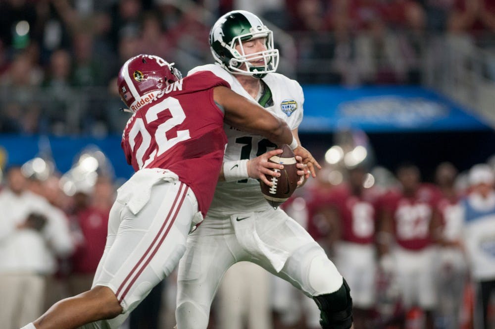 Alabama linebacker Ryan Anderson sacks senior quarterback Connor Cook for a loss of four yards in the second quarter during the Goodyear Cotton Bowl Classic on Dec. 31, 2015 at AT&T Stadium in Arlington, Texas. Alabama leads at the half, 10-0.