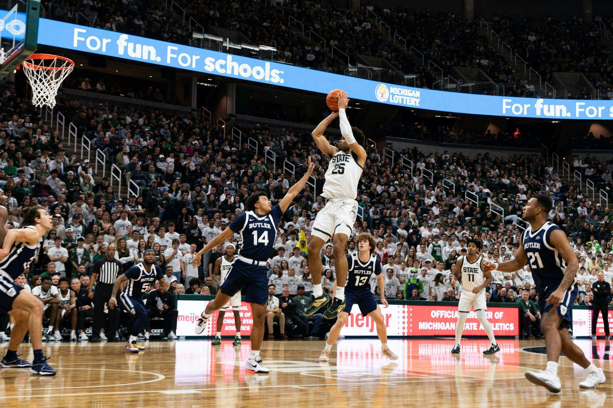 MSU forward Malik Hall shoots a jumper over Butler guard Landon Moore at the Breslin Center on Friday, Nov. 17, 2023. Hall went 6-9 during the matchup, recording 9 rebounds and 3 assists.