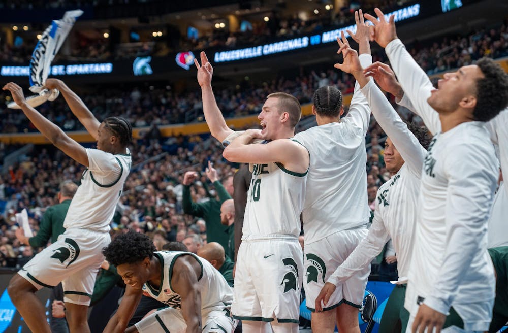 The MSU bench celebrates a three-pointer during  the March Madness matchup against University of Louisville at the KeyBank Center in Buffalo, New York on March 21, 2026.
