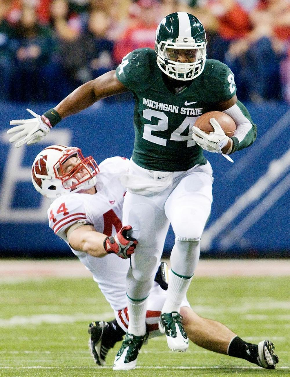 Then-sophomore running back Le'Veon Bell dashes forward as he breaks a tackle by Wisconsin linebacker Chris Borland. The Wisconsin Badgers defeated the Spartans, 42-39, on Dec. 13, 2011 at Lucas Oil Stadium in Indianapolis. State News File Photo