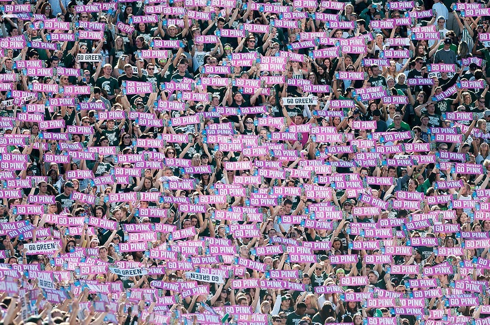 	<p>The student section holds up &#8220;Go Pink&#8221; signs during the game against Indiana, Oct. 12, 2013, at Spartan Stadium. The signs were passed out upon entry to the stadium in support of breast cancer awareness month. Danyelle Morrow/The State News</p>