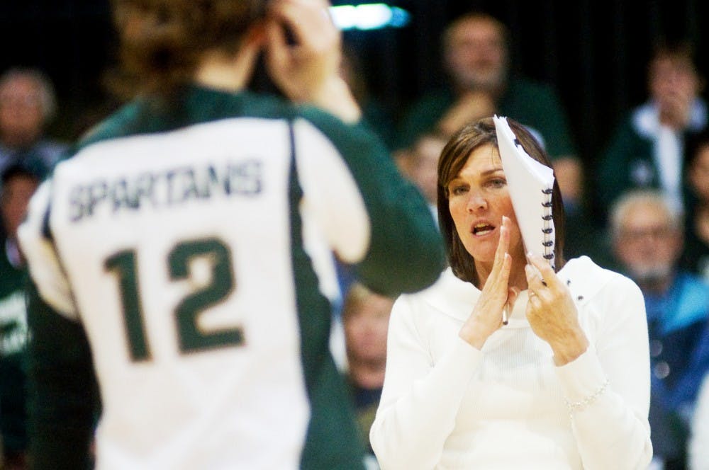 Volleyball head coach Cathy George talks with sophomore setter Kristen Kelsay at Jenison Field House Friday evening. Nebraska defeated MSU in a five-set overtime by 3-2. Justin Wan/The State News