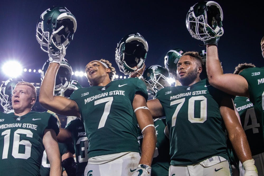 Sophomore wide receiver Cody White (7) and junior offensive lineman Tyler Higby (70) celebrate in front of the student section after the game against Utah State on Aug. 31 at Spartan Stadium. The Spartans defeated the Aggies, 38-31.