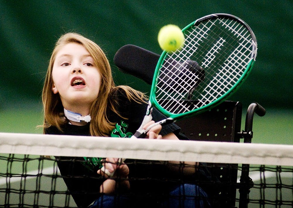 Katie Frayer, 15, of DeWitt, Mich., hits the ball April 4, 2012, at the MSU Tennis Center, 3571 E. Mount Hope Ave., in Lansing. Each Wednesday, men's tennis coach Gene Orlando teaches tennis to people in wheelchairs from 6 to 8 p.m. State News File Photo