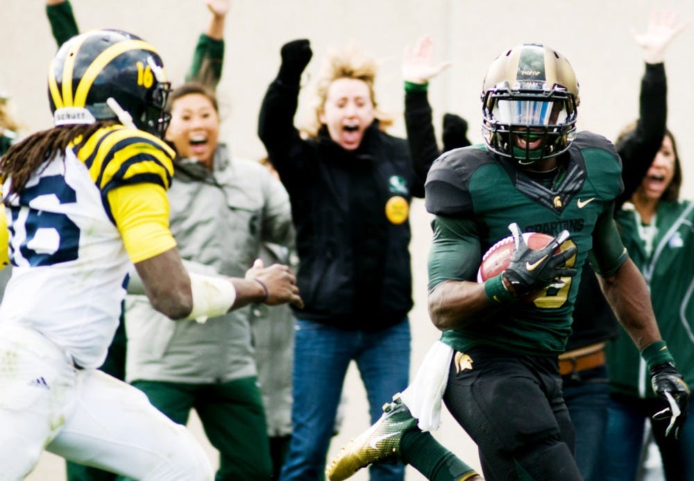 Then-sophomore safety Isaiah Lewis runs into the endzone after intercepting Michigan quarterback Denard Robinson's pass on Oct. 15, 2011 at the game against Michigan at Spartan Stadium. State News File Photo