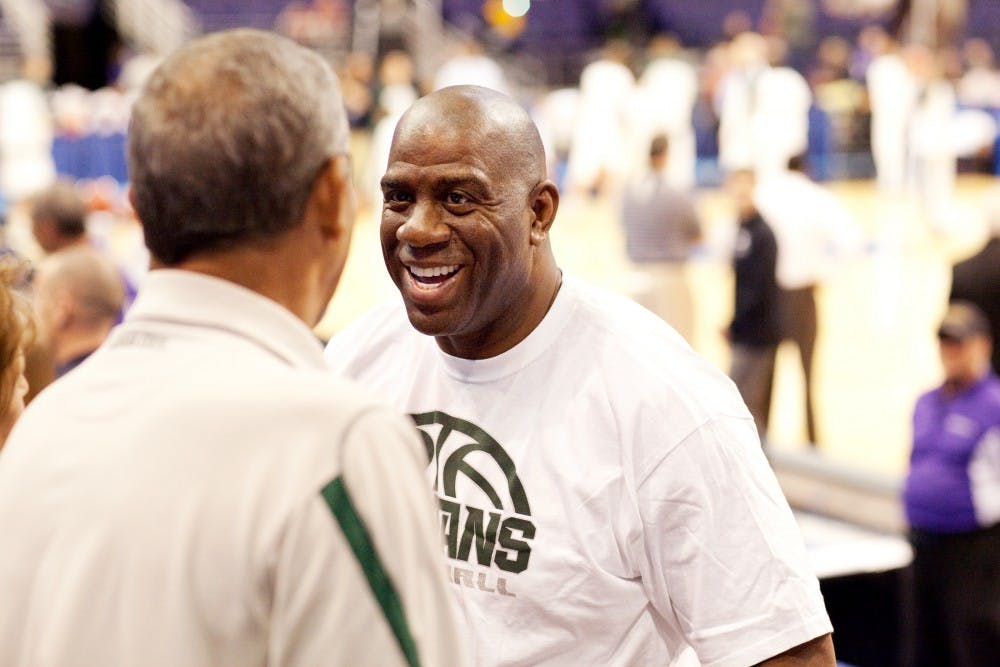 Spartan basketball legend Magic Johnson talks with Scottsdale, Az. resident Wendell Mourning Thursday afternoon before the Spartans played Louisville in the Sweet Sixteen at US Airways Center in Pheonix, Az. Matt Hallowell/The State News