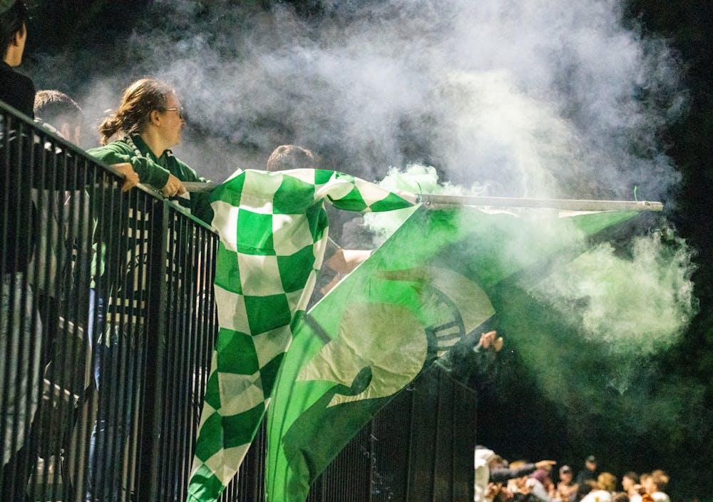 <p>The student section waves a Spartan flag and sets off green smoke as the MSU men&#x27;s soccer team runs onto the pitch after their win against the University of Michigan men&#x27;s soccer team at DeMartin Stadium on Sept. 27, 2022. Spartans defeated the Wolverines 2-0. </p>