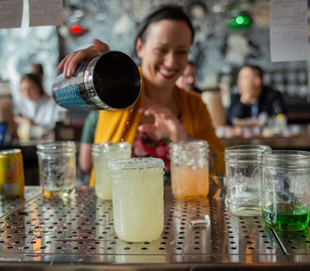 <p>Drinks are prepared at the bar during Barrio’s grand opening on March 9, 2020.</p>