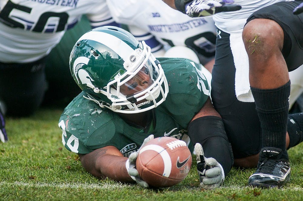 	<p>Junior running back Le&#8217;Veon Bell falls inches short of the goal line on Saturday, Nov. 17, 2012, at Spartan Stadium. Bell finished the game with 133 rushing yards in the Spartans&#8217; 23-20 loss to Northwestern. James Ristau/The State News</p>