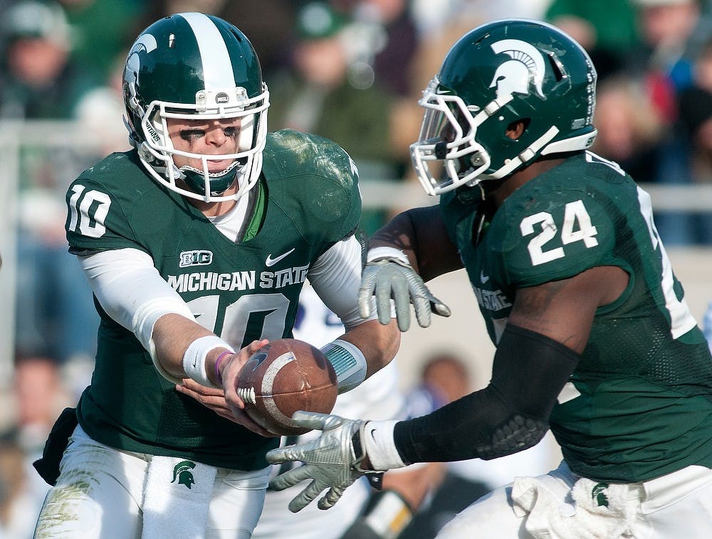 	<p>Junior quarterback Andrew Maxwell hands the ball to junior running back Le&#8217;Veon Bell in a play in the second half. The Spartans fell to the Wildcats, 23-20, Nov. 17, 2012, at Spartan Stadium during senior day. Justin Wan/The State News</p>