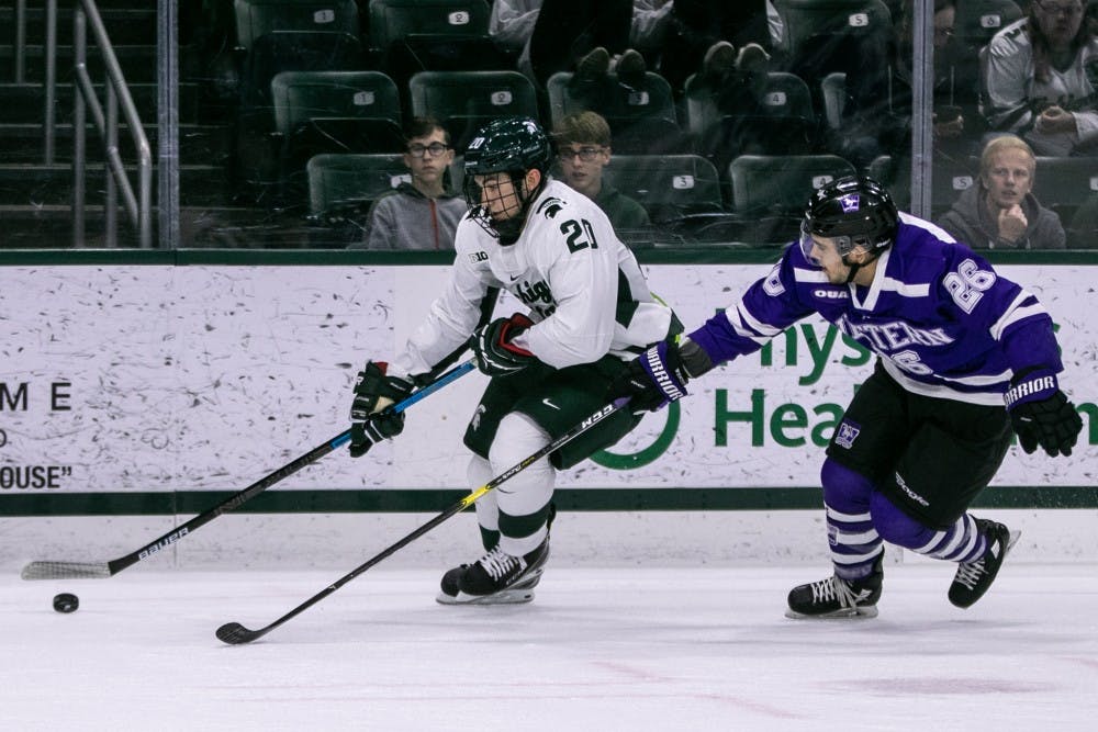 Freshman forward Josh Nodler (20) takes the puck up the ice during the game against Western Ontario at Munn Ice Arena Oct. 7, 2019. The Spartans defeated the Mustangs, 6-1.