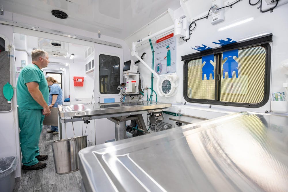 <p>MSU Assistant Professor, Dr. David Emery, works with Licensed Veterinary Technicians, Katlyn Cunningham and Rebecca Wood to clean up the MSU Veterinary Mobile Unit after completing many operations on dogs at I Heart Dogs in Warren, Mich., on July 16, 2026.</p>