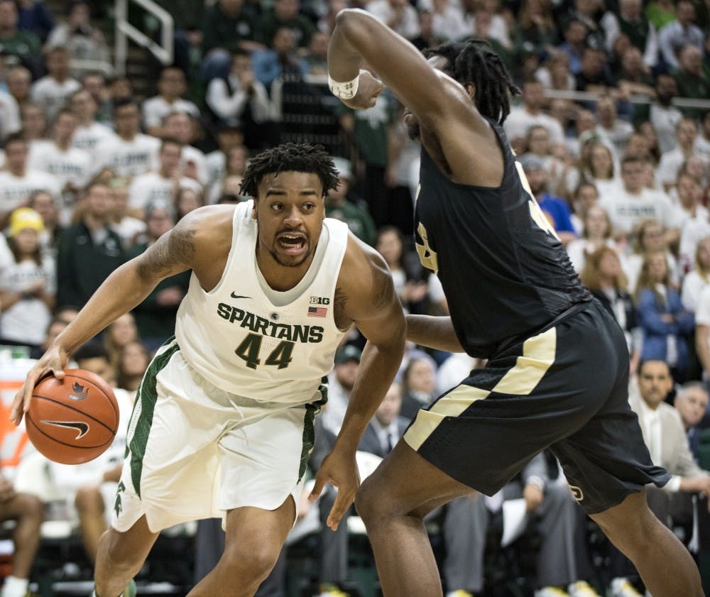 Freshman forward Nick Ward (44) looks to pass the ball as he is defended by Purdue forward Caleb Swanigan (50) during the second half of the men's basketball game against Purdue on Jan. 24, 2017 at Breslin Center. The Spartans were defeated by the Boilermakers, 84-73.
