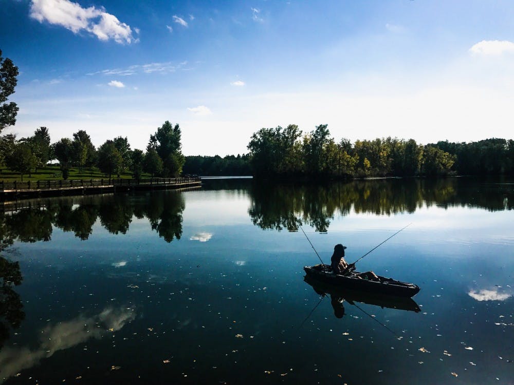 Antonio Alicea of Lansing waits for a catch while sitting in his kayak on Sept. 18, 2017 at Hawk Island County Park at 1601 E. Cavanaugh Rd. in Lansing. 