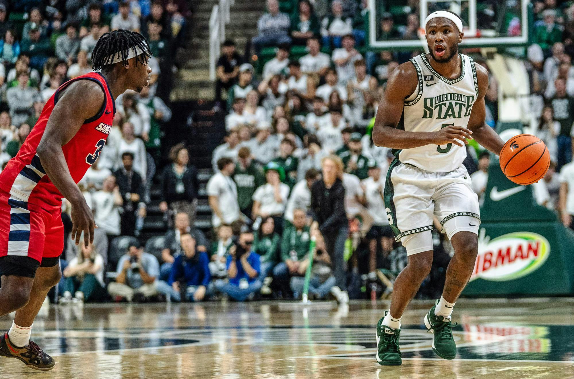 Michigan State University junior guard Tre Holloman (5) begins to run down the court in the Breslin Center on Nov. 19, 2024. 