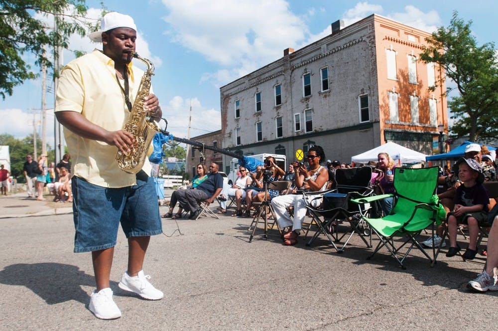 496 West saxophonist Reggie Page performs at the 2012 Lansing JazzFest in Old Town on Saturday Aug. 4, 2012. "I like to come down and actually interact," Page said about the audience. Julia Nagy/The State News