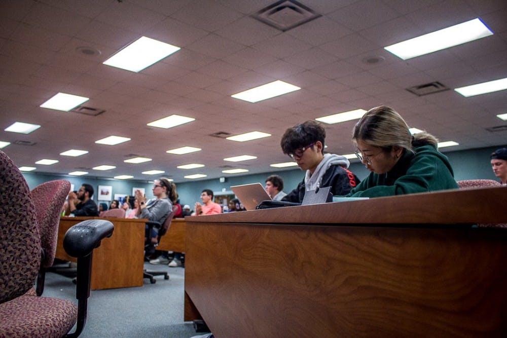 Students take notes during Dalia Mogahed's talk on the Muslims and US politics on Oct. 1, 2018 at the International Center. 