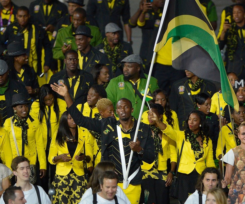 Flag bearer and track star Usain Bolt leads the Jamaica Olympic team as it marches in Olympic Stadium during the Opening Ceremony for the London 2012 Summer Olympic Games in London, England, Friday, July 27, 2012. (David Eulitt/Kansas City Star/MCT)