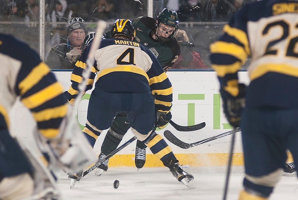 <p>Junior forward Matt DeBlouw looks for the puck Feb. 7, 2015 during the Michigan State hockey game against Michigan at Soldier Field in Chicago, Illinois.  The Spartans were defeated by the Wolverines 4-1 during the Coyote Logistics Hockey City Classic. Alice Kole/The State News</p>