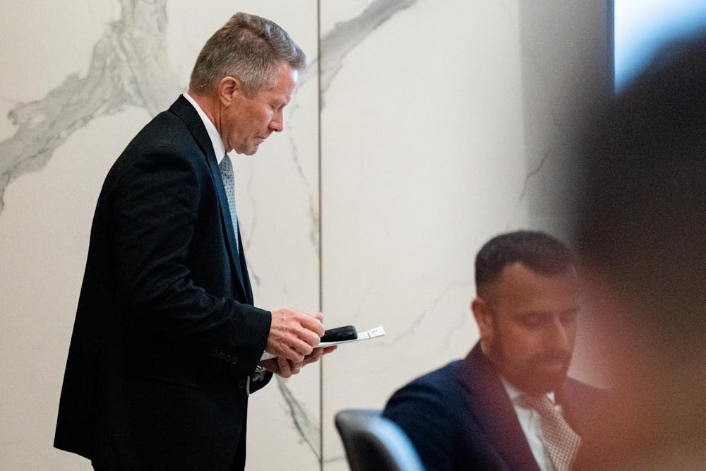 <p>Michigan State University President Kevin Guskiewicz walks back into the meeting after a short time out of sight at the MSU Board of Trustees meeting at Hannah Administration Building in East Lansing, Michigan on Friday, Dec. 12, 2025.</p>