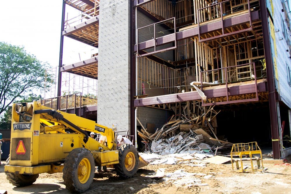 Workers begin the cleanup of the collapsed fourth floor of St. Anne Lofts on Monday evening, June 18, 2012. Structural engineers are in the process of figuring out what went wrong. Natalie Kolb/The State News