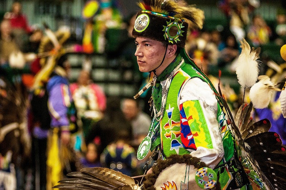 	<p><span class="caps">MSU</span> alumnus and head male dancer Marcus Winchester dances to a traditional song Feb. 22, 2014, at the 31st annual Powwow of Love event put on by the North American Indigenous Student Organization at Jenison Fieldhouse. Winchester is of the Potawatomi Tribe and said that he loves being a part of events like the pow-wow, because it is fun. </p>