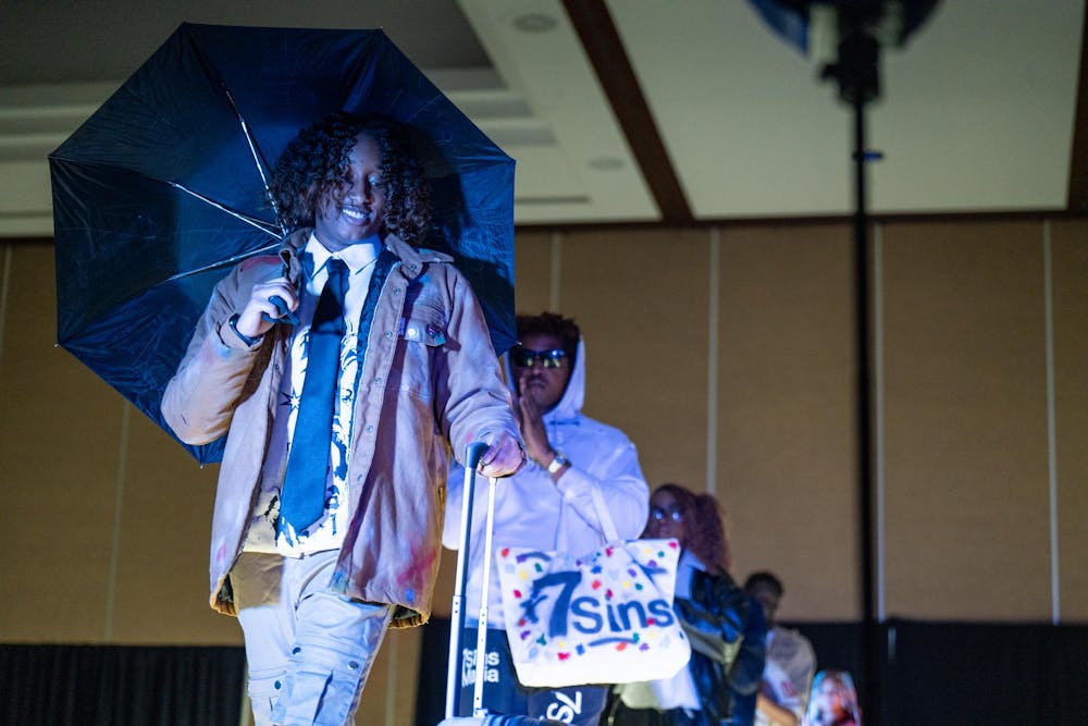 Models of 7 Sins Mafia’s collection walk across the stage during N Crowd magazine’s fall fashion show at The Lansing Center on Dec. 8, 2024. N Crowd, a fashion magazine and non-profit organization for creatives at MSU, holds a fashion show every semester.
