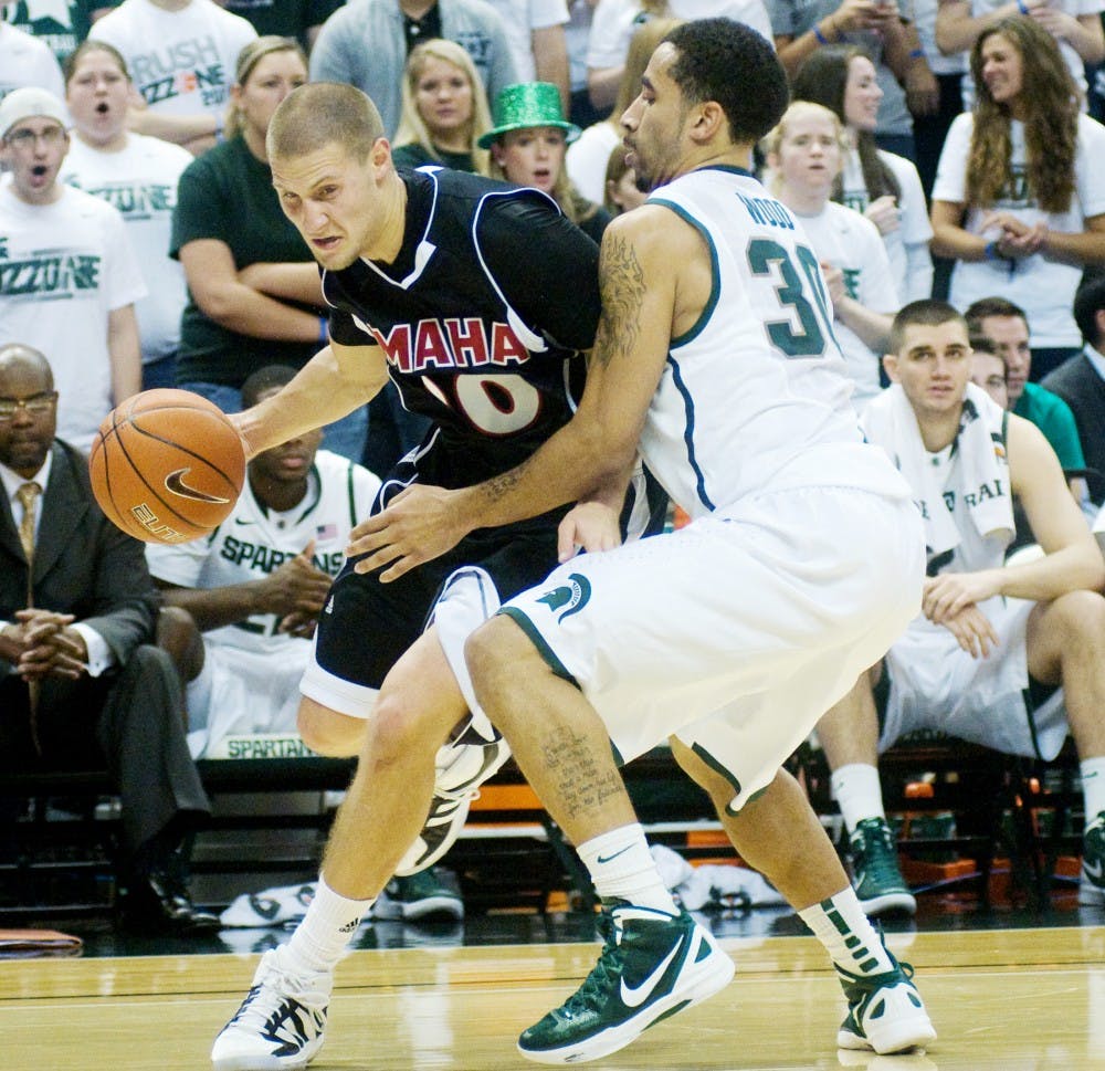 Red shirt senior guard Brandon Wood plays tight defense against Maverick guard Mitch Albers. The Spartans defeated the Mavericks 110-68 Sunday afternoon at Breslin Center. Anthony Thibodeau/The State News