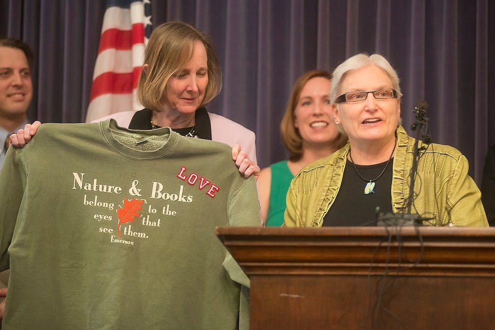 <p>Marsha Caspar addresses the U.S. 6th Circuit Court of Appeals temporary stay on gay marriages in Michigan as her wife Glenna DeJong, left, holds the shirt Caspar was wearing at their wedding March 25, 2014, at the Capital Building. The couple, who were the first gay couple in Michigan to wed, were joined by other Michigan government officials at the press conference to fight for marriage equality. Julia Nagy/The State News</p>