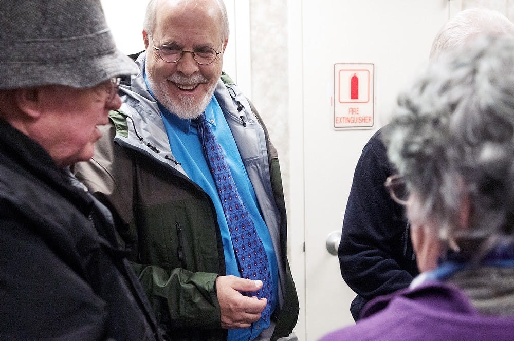 <p>Ingham County Drain Commissioner Pat Lindemann talks with Lansing residents Pat, left, and Carla Barnes.  The Barnes couple currently lives in the affected area that will undergo the new drainage system.  Allison Brooks/The State News </p>