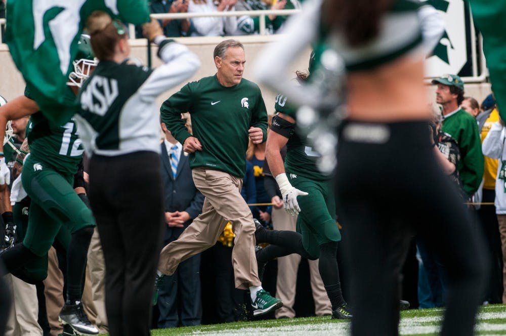 Head coach Mark Dantonio runs out onto the field during the game against the University of Michigan on Oct. 29, 2016 at Spartan Stadium. The Spartans were defeated by the Wolverines, 32-23.