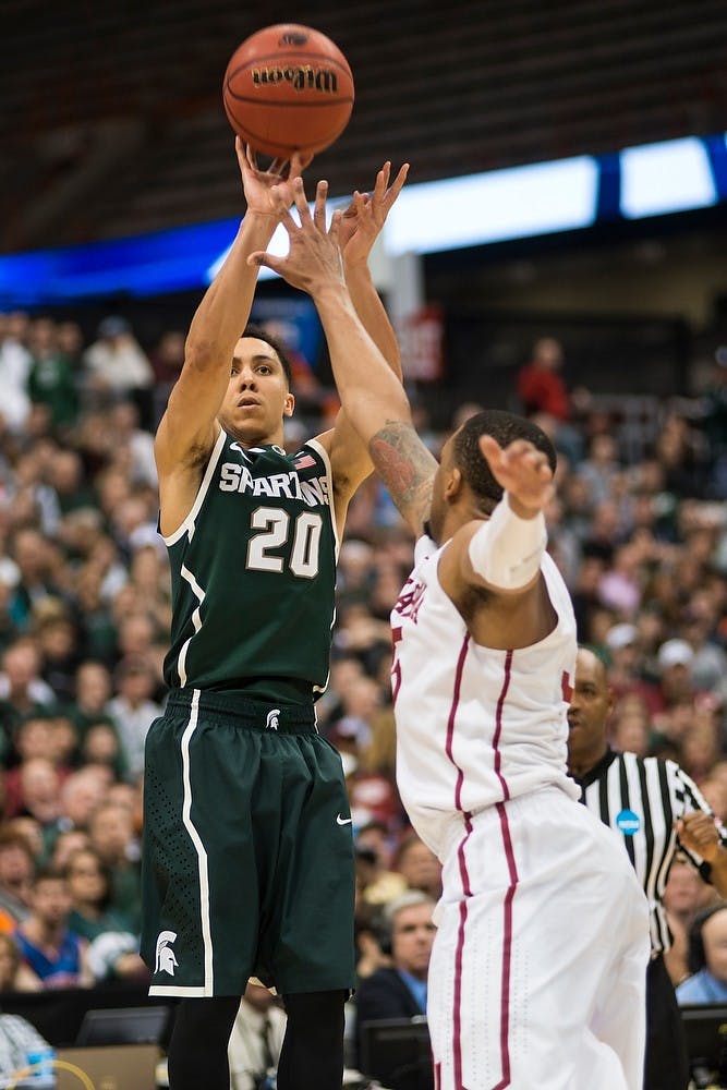 <p>Senior guard Travis Trice attempts a point March 27, 2015, during the East Regional round of the NCAA Tournament in a game against Oklahoma at the Carrier Dome in Syracuse, New York. The Spartans the Sooners, 62-58. Erin Hampton/The State News</p>
