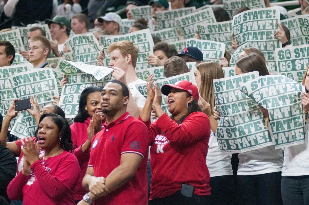 Nebraska fans in the Izzone cheer for the Cornhuskers while MSU fans pretend to be uninterested during the game against Nebraska on Dec. 3, 2017, at Breslin Center. The Spartans defeated the Cornhuskers 86-57.