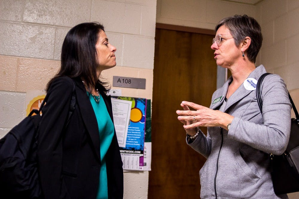 <p>Democratic nominee for attorney general Dana Nessel listens to Democratic nominee for state representative Julie Brixie on Oct. 22, 2018 at Wells Hall. Nessel is running for Michigan attorney general in the upcoming election.</p>