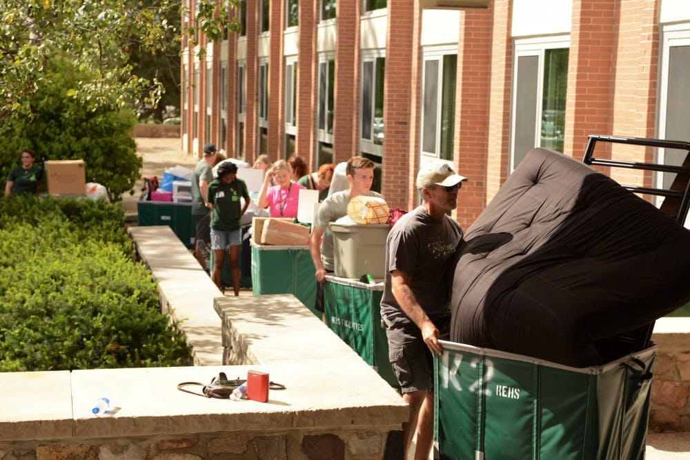<p>Families of new and returning students waiting in line to move in to South Hubbard Hall during Fall move in day on Aug. 25, 2019.</p>