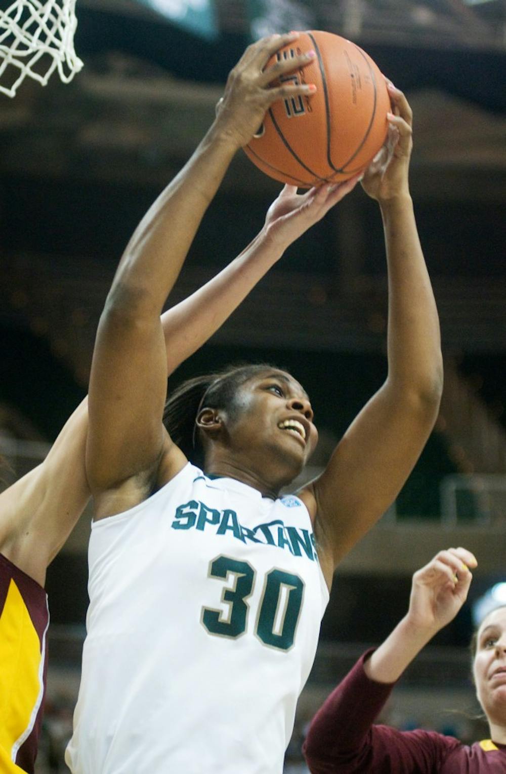 Junior forward Lykendra Johnson snatches a rebound from Minnesota on Sunday at Breslin Center. Johnson led the Spartans to a, 66-54, win with 17 rebounds and 20 points. Kat Petersen/The State News