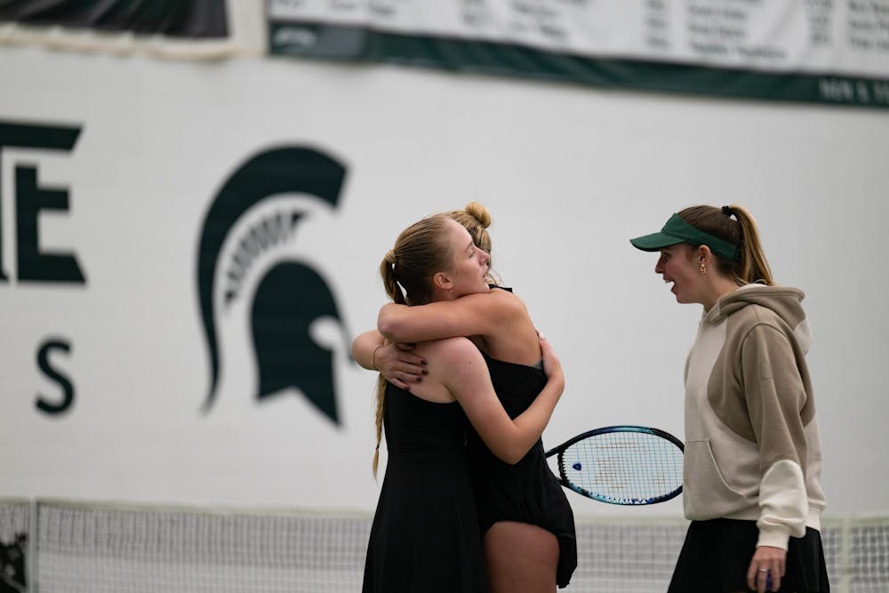 Members of the Michigan State women’s tennis team hug Hanna Tsitavets, a redshirt junior, after her match victory at the MSU Tennis Center on Friday, Feb. 6, 2026