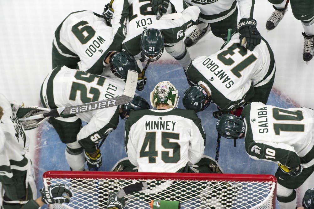 The Spartans huddle before the game against Penn State on Feb. 25, 2017 at Munn Ice Arena. The Spartans were defeated by the Nittany Lions, 4-1