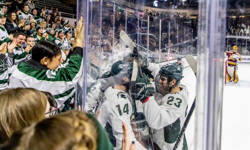 The Spartan players celebrate with the Spartan fans after a goal during the game against Minnesota on Jan. 20, 2019. The Spartans are tied with the Golden Gophers 1-1 at the end of the first period.